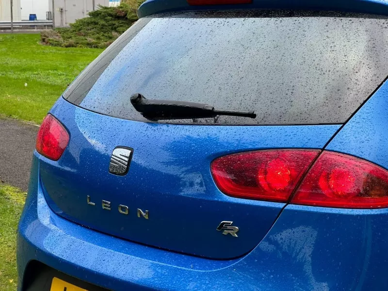 Rear Wiper Blade Clearing Rain from a Hatchback Rear Window